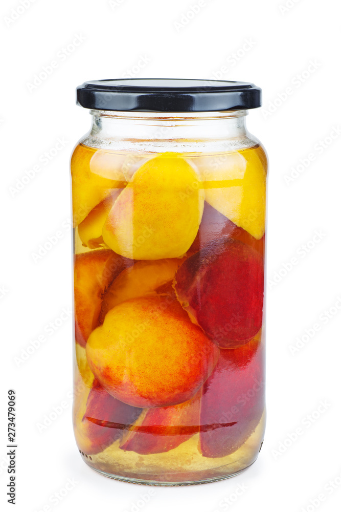 Peach slices canned in glass jar isolated on white background Peach slices canned in glass jar isolated on white background