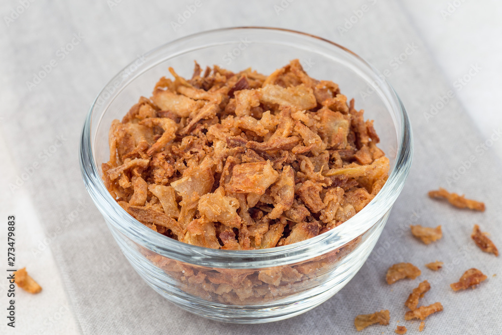 Fried onion in glass, topping for hot dog, fast food, horizontal Fried onion in glass, topping for hot dog, fast food, horizontal