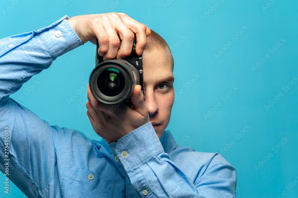 Young male guy photographer with dslr camera