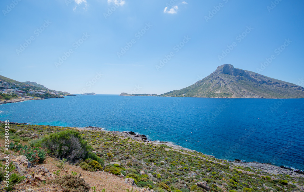 bright blue sea green hills and hills Island Telendos on the horizon in Greece Island Kalymnos