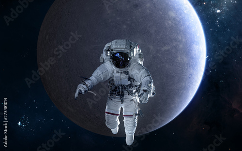 Astronaut on background of Mercury. Solar system. Science fiction. Elements of this image furnished by NASA