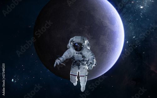 Fototapeta Naklejka Na Ścianę i Meble -  Astronaut on background of the Moon. Solar system. Science fiction. Elements of this image furnished by NASA