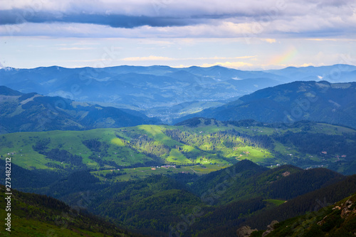 Beautiful swiss alps. Amazing mountain view with high peaks, green hills and clouds low in the valley photo