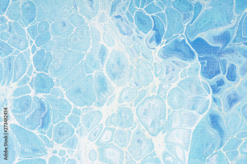 Beautiful background of liquid acrylic in blue and white on canvas