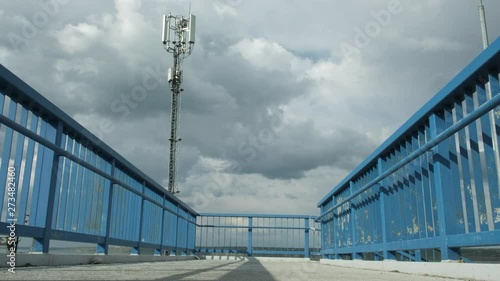 Telephone antenna on the bridge. Telecommunication tower against blue sky