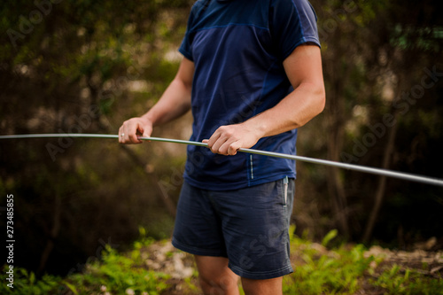 Man holding a metal frame ready to sets up a tent