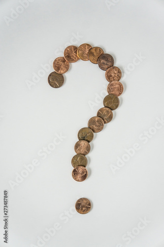 Question mark symbol made of American US pennies on white background