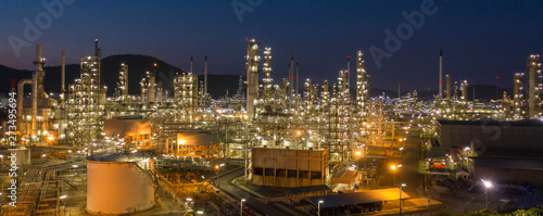 Aerial view. Oil refinery factory and oil storage tank at twilight and night. Petrochemical Industrial.  Banner background