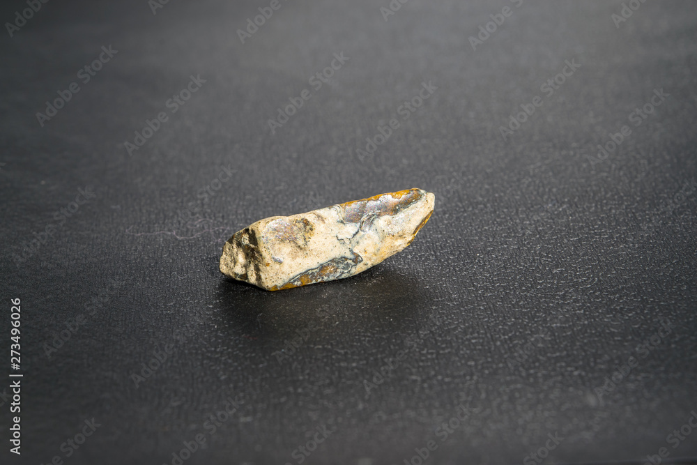 A small piece of opal on a black background A small piece of opal on a black background