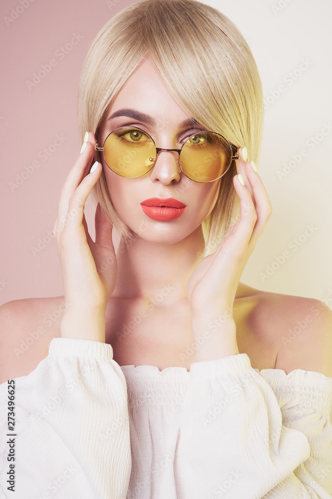 Sensual stylish woman in erotic white dress. Blue-eyed lady with perfect lips in modern colour sunglasses Sensual stylish woman in erotic white dress. Blue-eyed lady with perfect lips in modern colour sunglasses