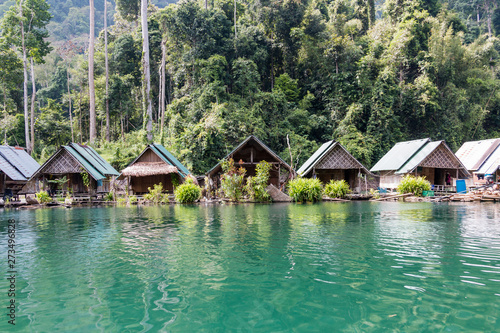 Tropical lakeside hut in ratchaprapa dam or Cheow Lan Dam Suratthani, Thailand.
