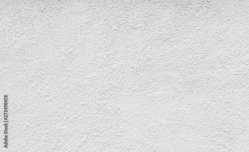 High resolution full frame background of a rough plastered concrete wall in black and white.