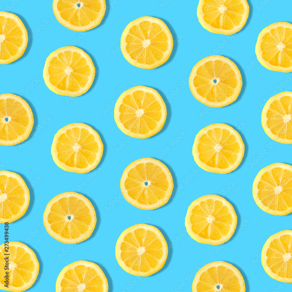 Summer fruit pattern of lemon slices on a blue background