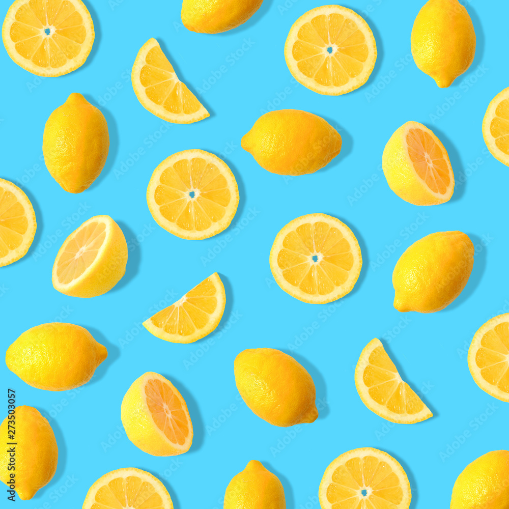 Summer fruit pattern of lemons and lemon slices on a bright blue background
