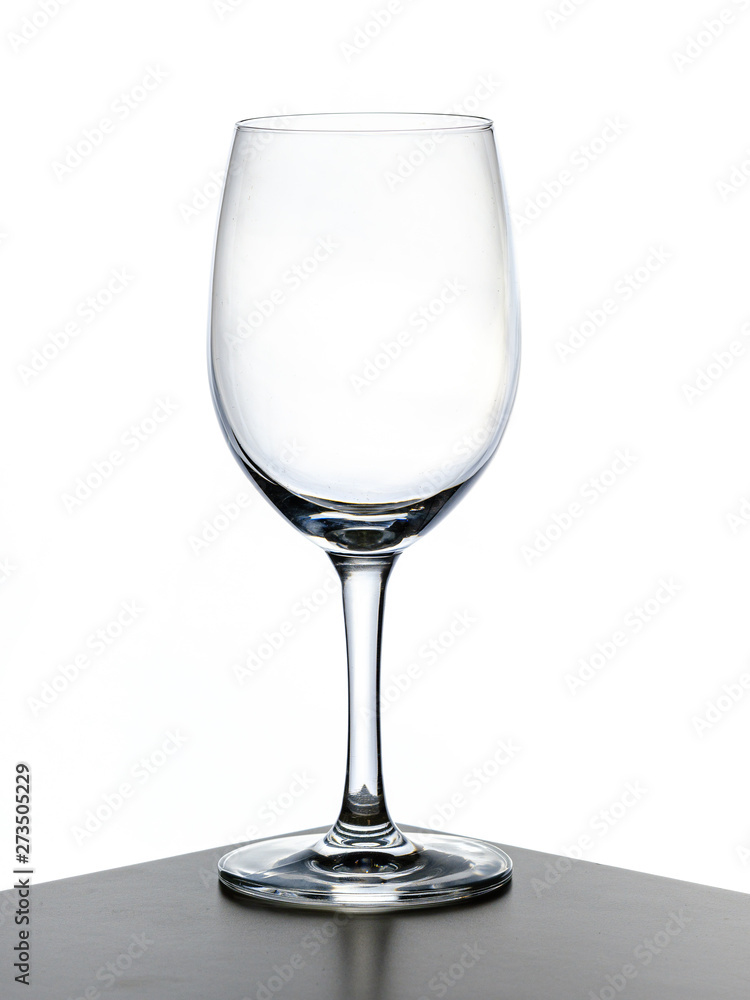 transparent wine glass with cognac being poured in transparent wine glass with cognac being poured in