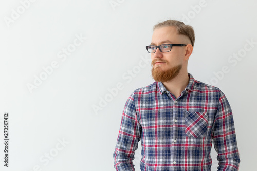 Portrait of thoughtful light blonde man with red beard over white background with copy space © satura_
