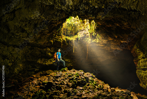Cave in the Azores with backpacker photo