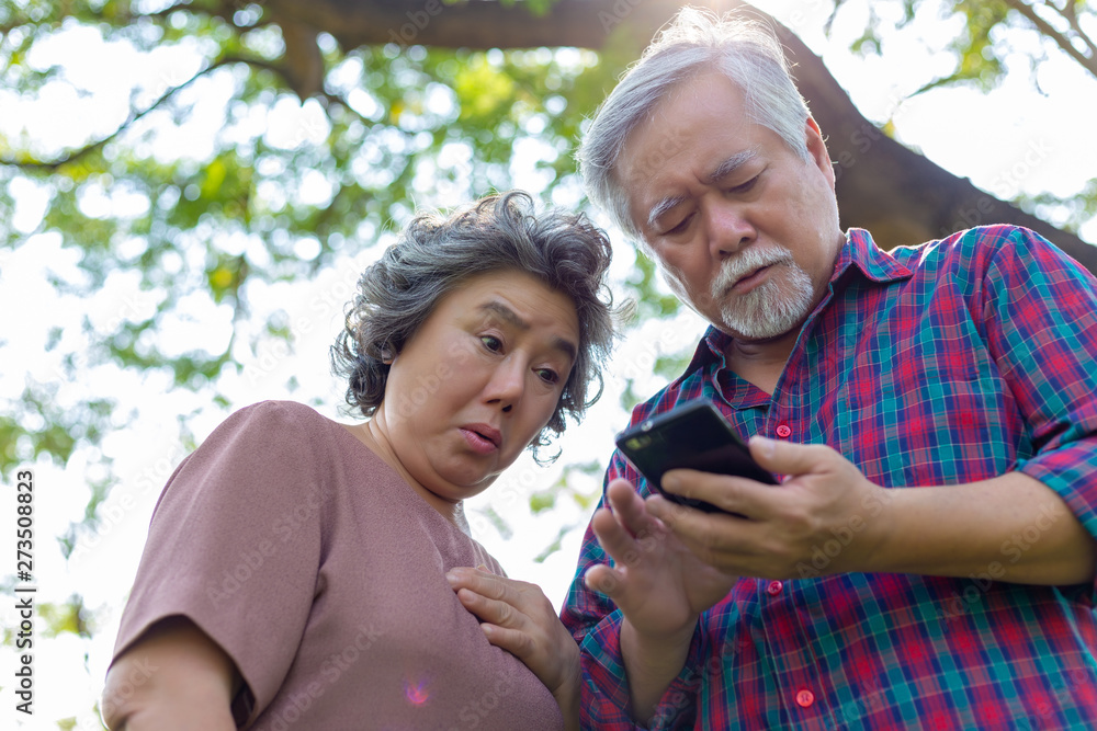 Grandmother and grandfather reading bad news or message that makes elderly woman and elderly man get nervous, stressed and shocked that one of family get accident or illness. Elder couple get unhappy Grandmother and grandfather reading bad news or message that makes elderly woman and elderly man get nervous, stressed and shocked that one of family get accident or illness. Elder couple get unhappy
