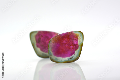 Beautiful watermelon tourmalines pink and green polished and shiny on white background