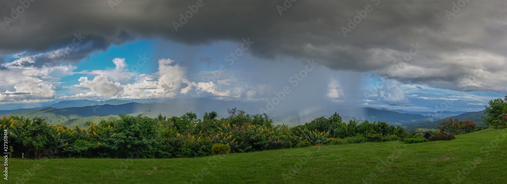 view panorama of heavy raining on top hill with dark cloudys background ...