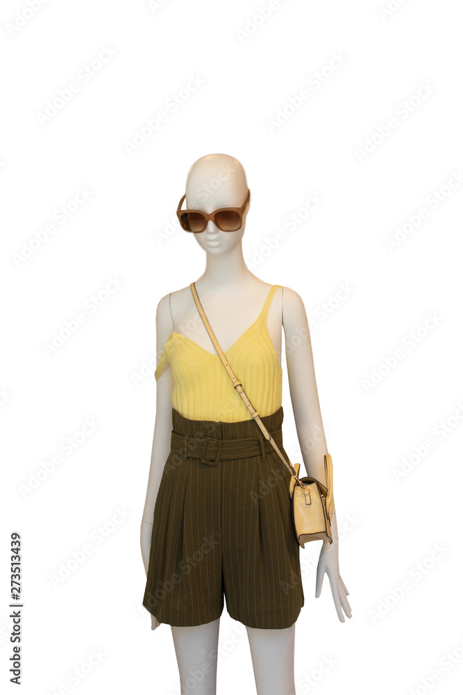 Woman shirt and short pants isolated. Mannequin dressed with female yellow shirt, elegant brown shorts, yellow handbag and sunglasses isolated on a white background. Summer fashion.