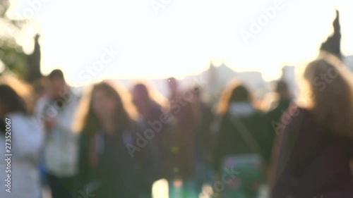 Crowd Of People Walking In The Street In City At Sunset. Blurred.