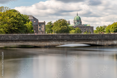 Buildings and bridge over  Corrib River with Cathedral in background © lisandrotrarbach