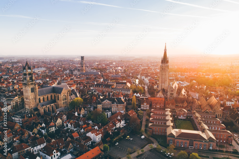 Fototapeta premium High top cityscape at sunrise. Church of Our Lady Bruges, Belgium.