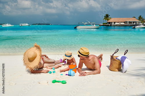 Fototapeta Naklejka Na Ścianę i Meble -  Family on beach, young couple with three year old boy. Summer vacation at Maldives.