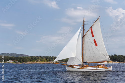 Small wooden sailboat in the sea