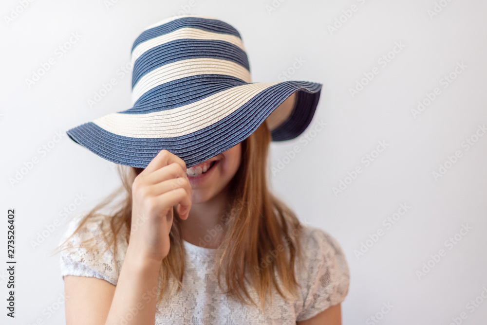 littlle girl in a striped summer hat littlle girl in a striped summer hat