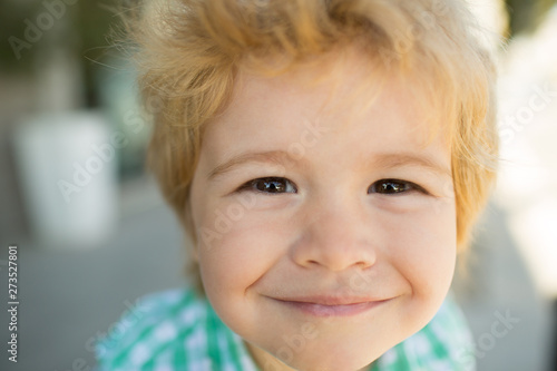 Photo of adorable young happy boy looking at camera. Happy funny child face close up. Super smile from kid. Happiness.