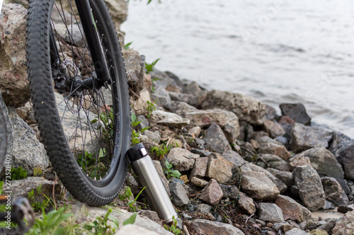 Cyclist in nature. Bicycle and flask. Traveling by bike. photo