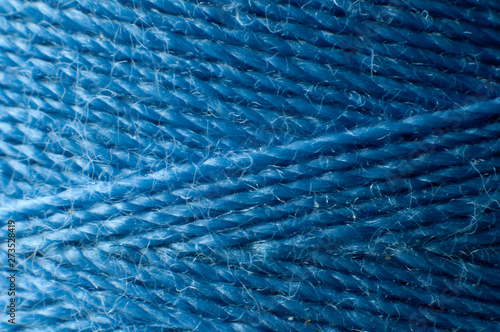 blue thread spooled up on a yarn spool