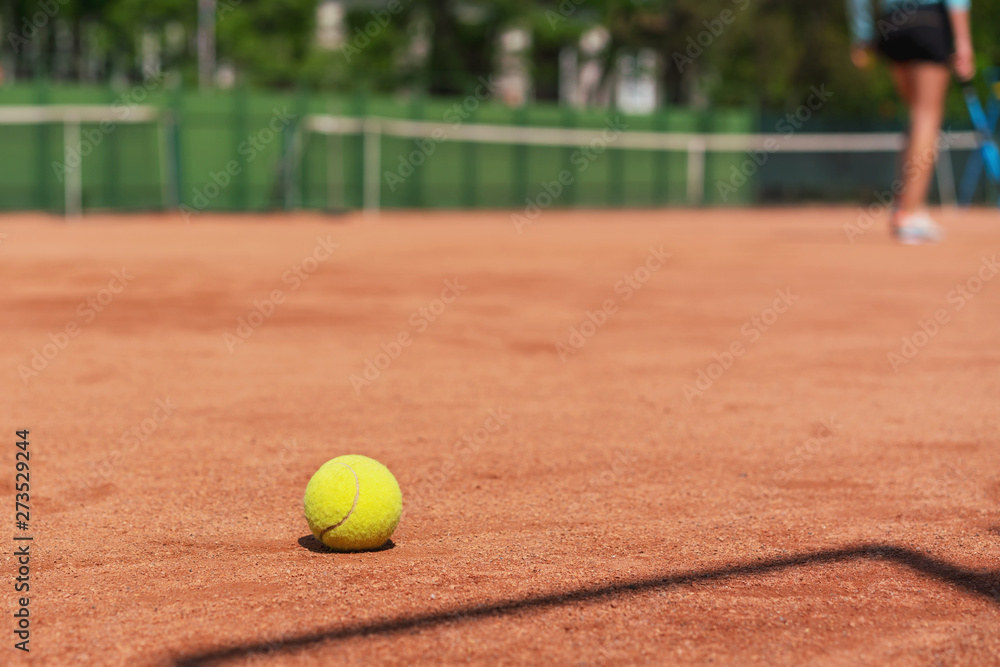yellow tennis ball on clay court outdoor, training camp in tennis academy