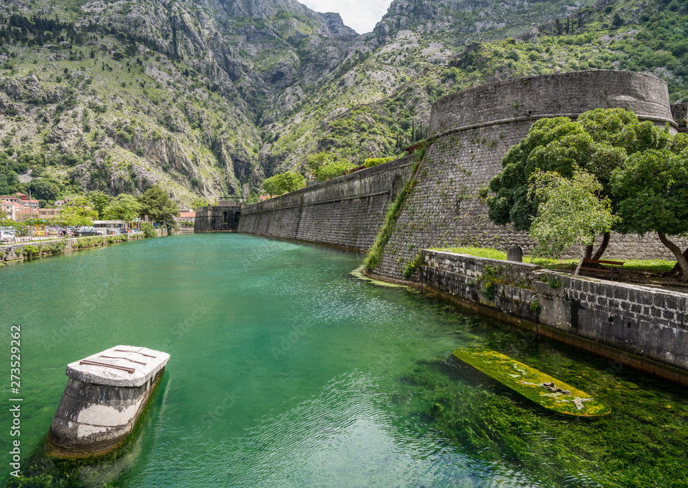 Fototapeta premium Solid stone walls surround the old town Kotor in Montenegro