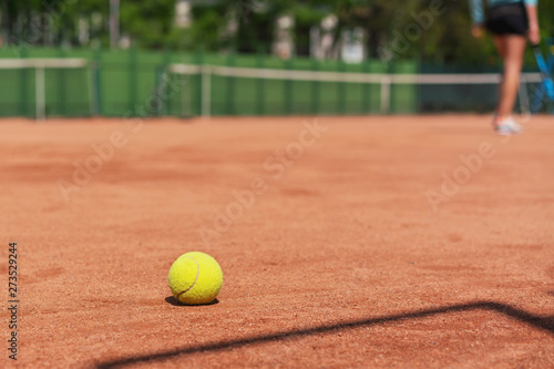 yellow tennis ball on clay court outdoor, training camp in tennis academy © Bonsales