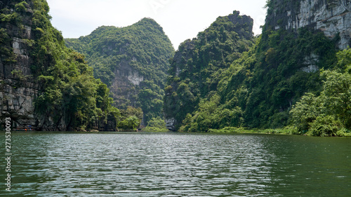Tropical forest, karst mountains and river in Ninh Binh, Trang An, Vietnam. © vadim_ozz