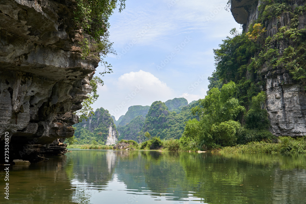River, karst mountains and tropical forest in Trang An, Tam Coc, Ninh Binh, Vietnam.