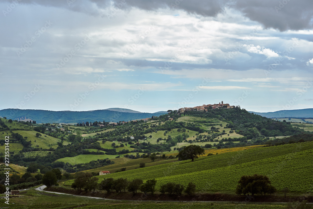 Rural landscape with buildings of the city on a hill in Tuscany, Italy..