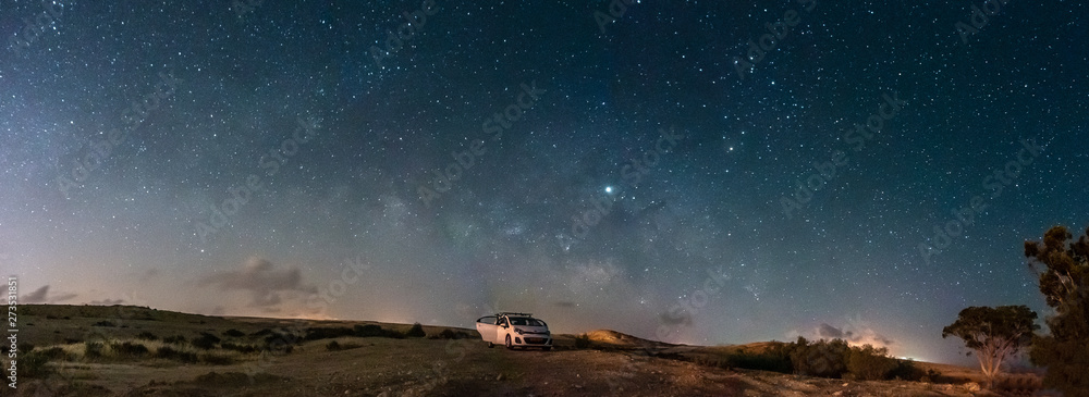 Milky way Panorama and white car in a park - obrazy, fototapety, plakaty 