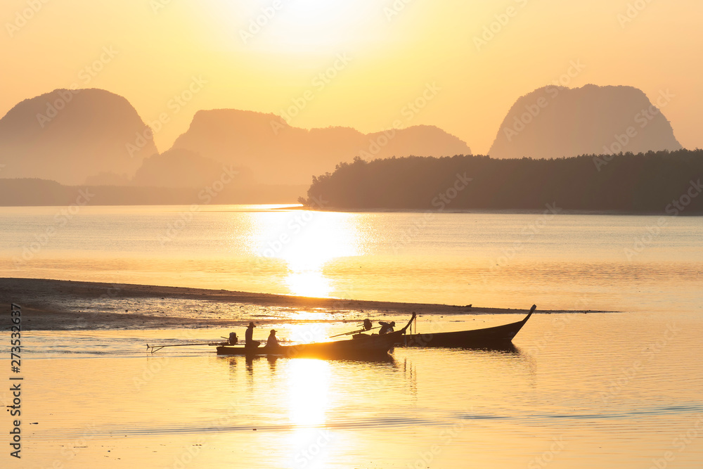 Silhouette photo of fisherman on boat go for fishing in morning in Krabi Thailand