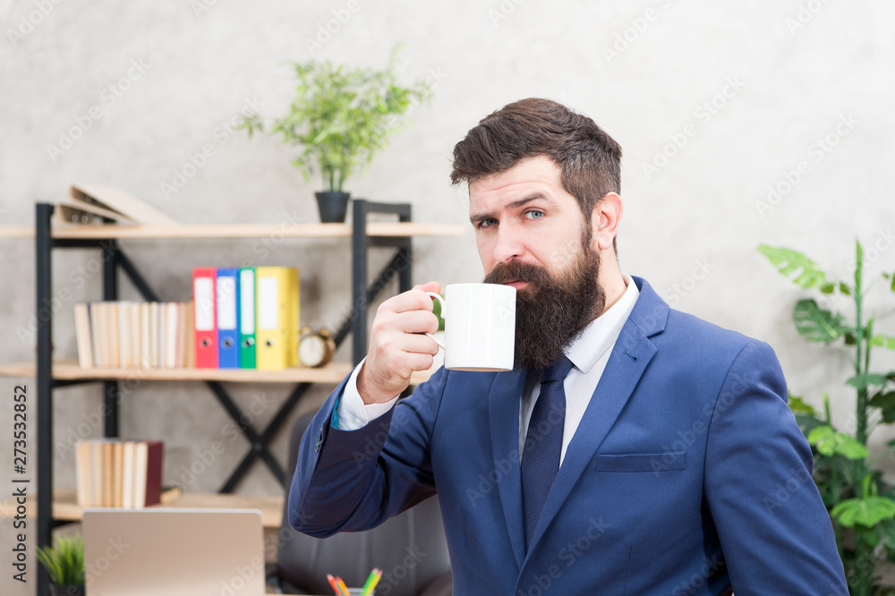 Man bearded businessman hold coffee cup stand office background. Start day with coffee. Successful people drink coffee. Drinking coffee relaxing break. Boss enjoying energy drink. Caffeine addicted Man bearded businessman hold coffee cup stand office background. Start day with coffee. Successful people drink coffee. Drinking coffee relaxing break. Boss enjoying energy drink. Caffeine addicted
