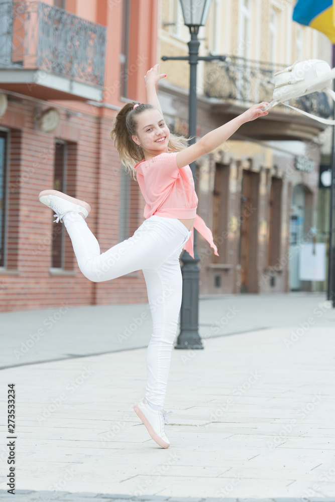 Born a dancer. Little female dancer performing choreography on street. Small cute girl dancer dancing tip toe on summer day. Adorable street dancer Born a dancer. Little female dancer performing choreography on street. Small cute girl dancer dancing tip toe on summer day. Adorable street dancer