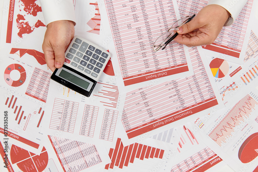 Obraz premium Flat top view of businessman working and calculating finance, reads and writes reports. Business financial accounting concept.