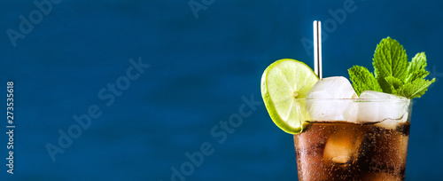 banner of Coca Coke cocktail in a tall glass cuba libre. refreshing summer drink