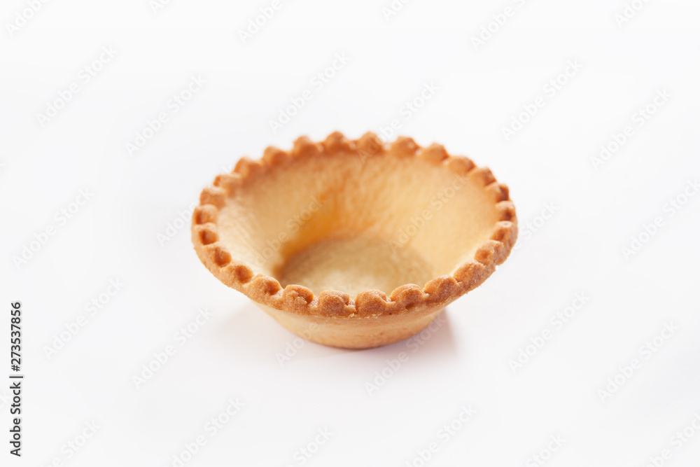 A small form of unleavened dough for serving snacks. Dough form for appetizers and desserts. Macro photo on white background. A small form of unleavened dough for serving snacks. Dough form for appetizers and desserts. Macro photo on white background.