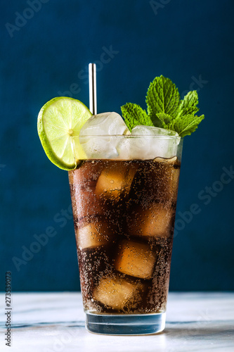 Coca Coke cocktail in a tall glass cuba libre. refreshing summer drink