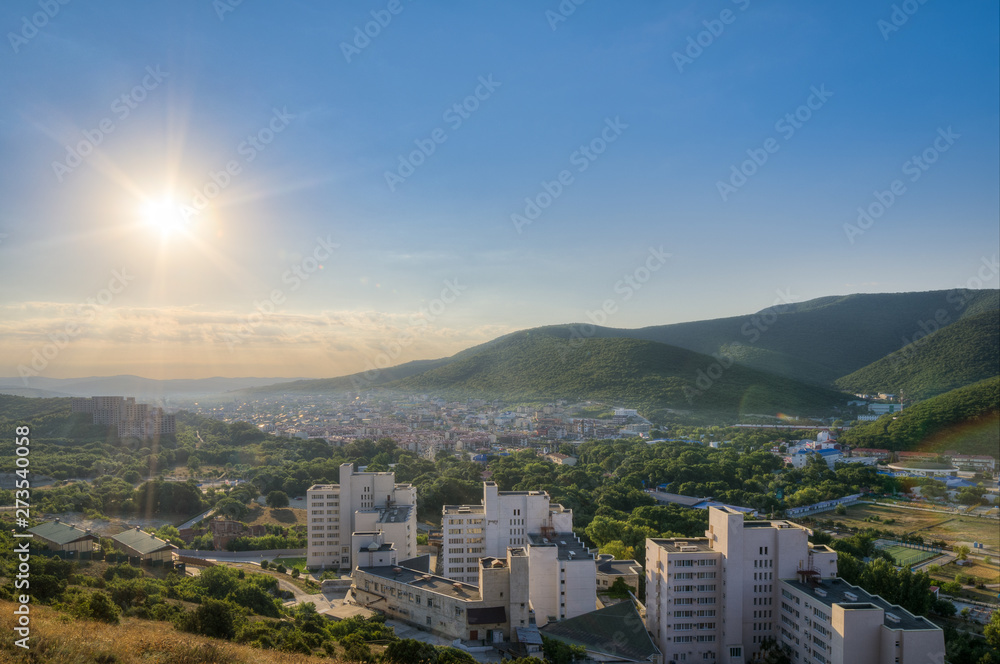 Obraz premium The dawn of urban settlement in the mountains. The village of Sukko, Anapa, Krasnodar region, Russia. Horizontal frame.