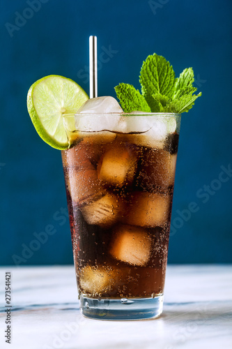 Coca Coke cocktail in a tall glass cuba libre. refreshing summer drink